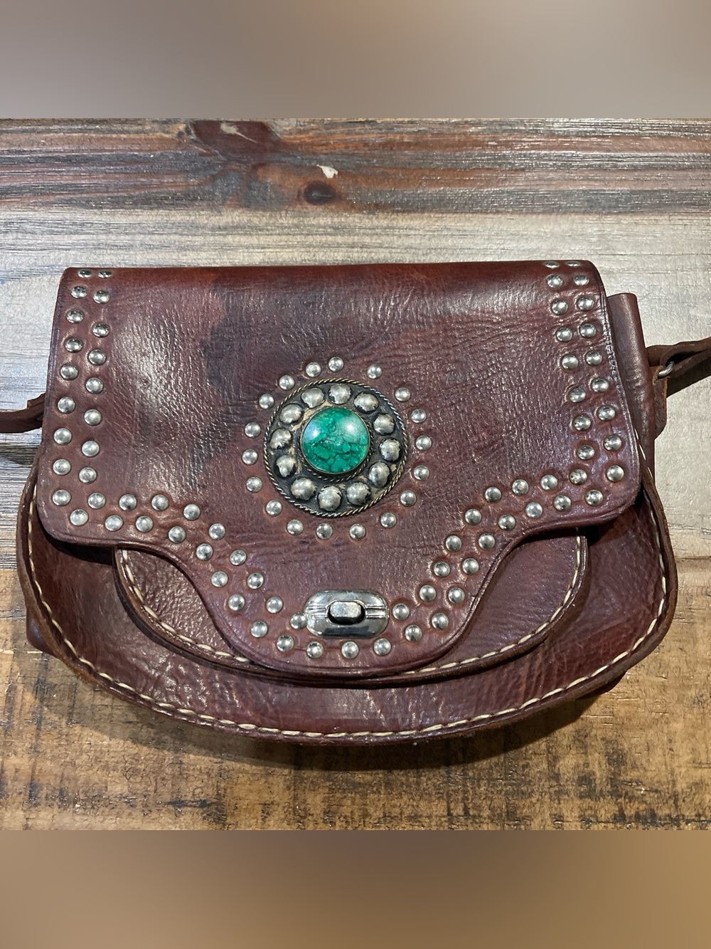 Brown Leather Crossbody Bag with Turquoise Accent and Stud Detailing